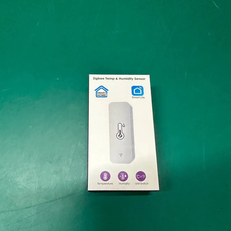 Compact white WiFi temperature and humidity sensor with digital display on ABS plastic case.