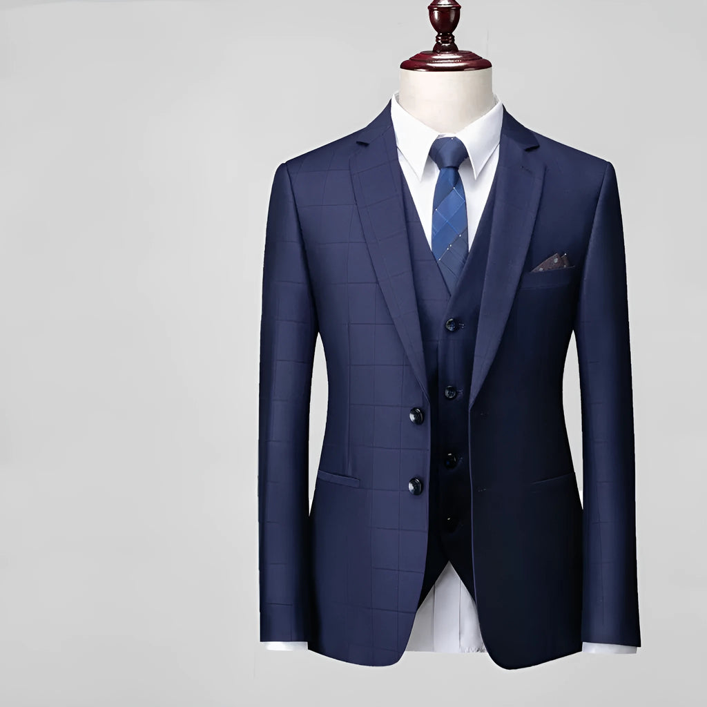 Men's navy blue slim fit three-piece suit with jacket, vest, and trousers on a hanger.