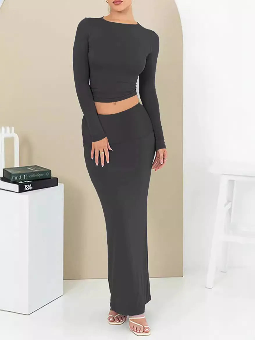 Women's sweet style two-piece suit with a cropped top and long skirt in polyester fabric.