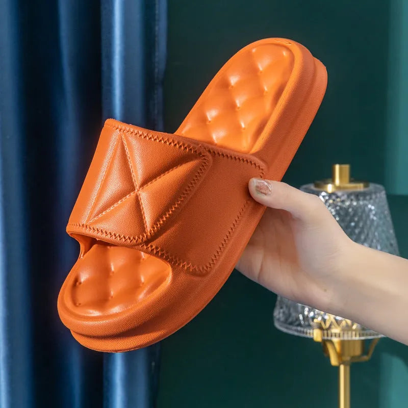 A pair of soft EVA bathroom slippers with a thick, textured non-slip sole in a choice of colours.