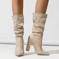 Women's black suede pointed-toe high heel boots with a chunky mid-calf design.