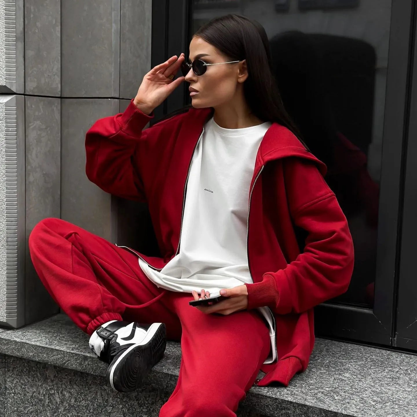 Street style loose fit two-piece set showing long-sleeved coat and matching trousers in solid colour