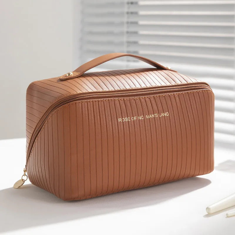 PU leather vertical pattern pillow makeup bag with cubic shape in travel setting