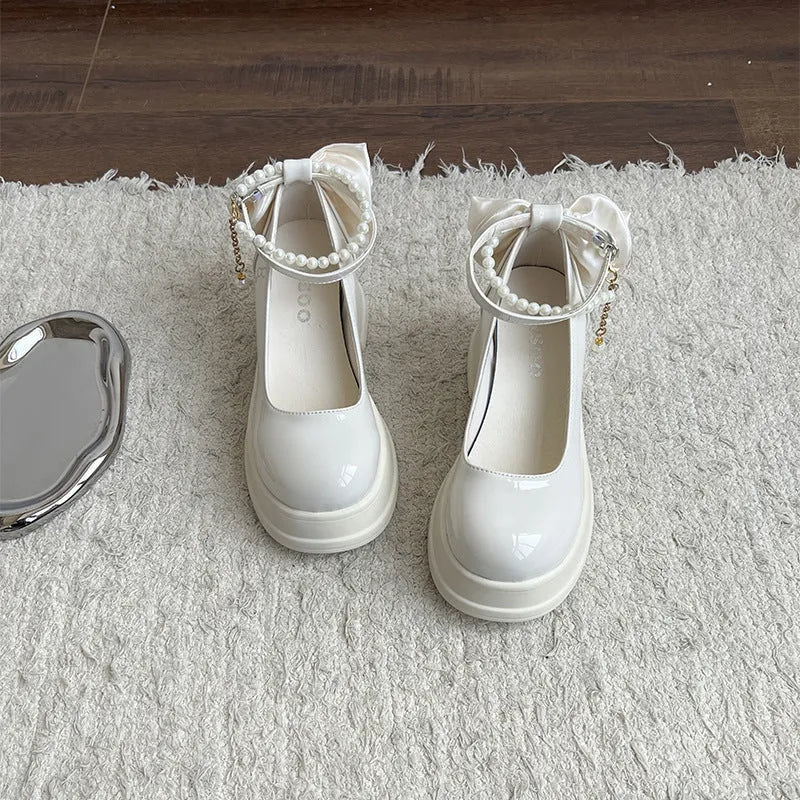 Beige and black women's Mary Jane shoes with a chunky block heel and round toe.