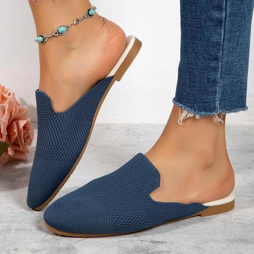 A pair of apricot-coloured mesh slip-on flat sandals with a round toe and rubber sole.