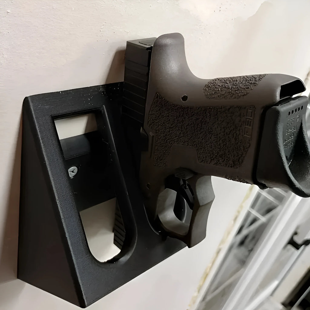 Black plastic pistol display stand for model firearms measuring 10.85 by 7.6 centimetres