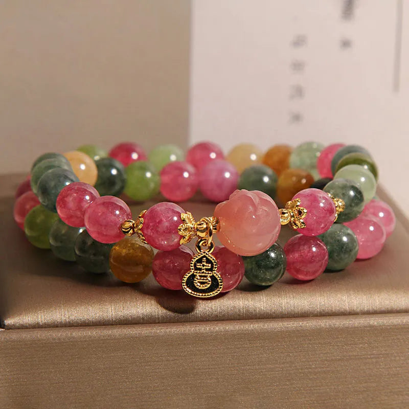 Natural jade colour tourmaline crystal double ring bracelet for women with Buddha head charm on white background