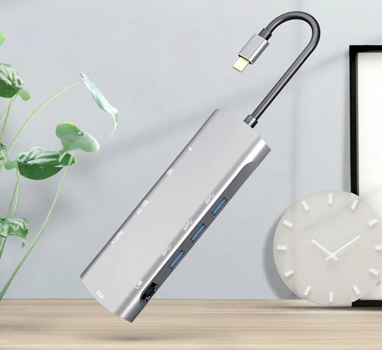 Grey USB-C docking station with HDMI, VGA, and USB ports on aluminium alloy body