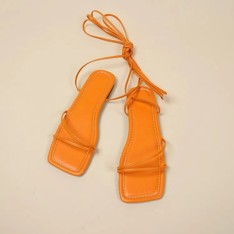 Women's white ankle wrap bandage strap flat sandals with square toe and front lace-up fastening.