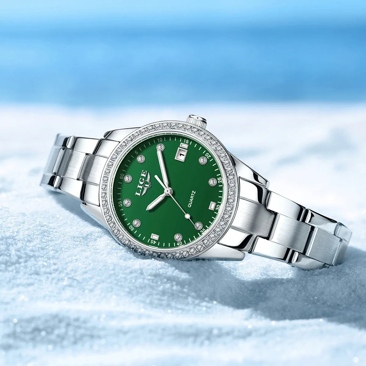 Silver fashion quartz watch with diamond-encrusted round dial and stainless steel case on wrist.