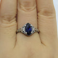 Silver geometric hollow women's ring on grey background showing detailed pattern