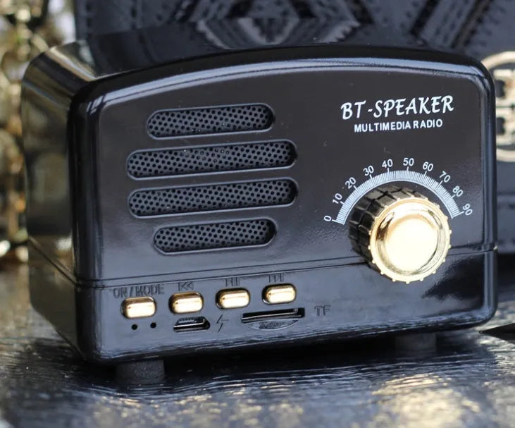 Vintage wood finish bluetooth speaker in pink, black, and wood grain colour options showing compact design