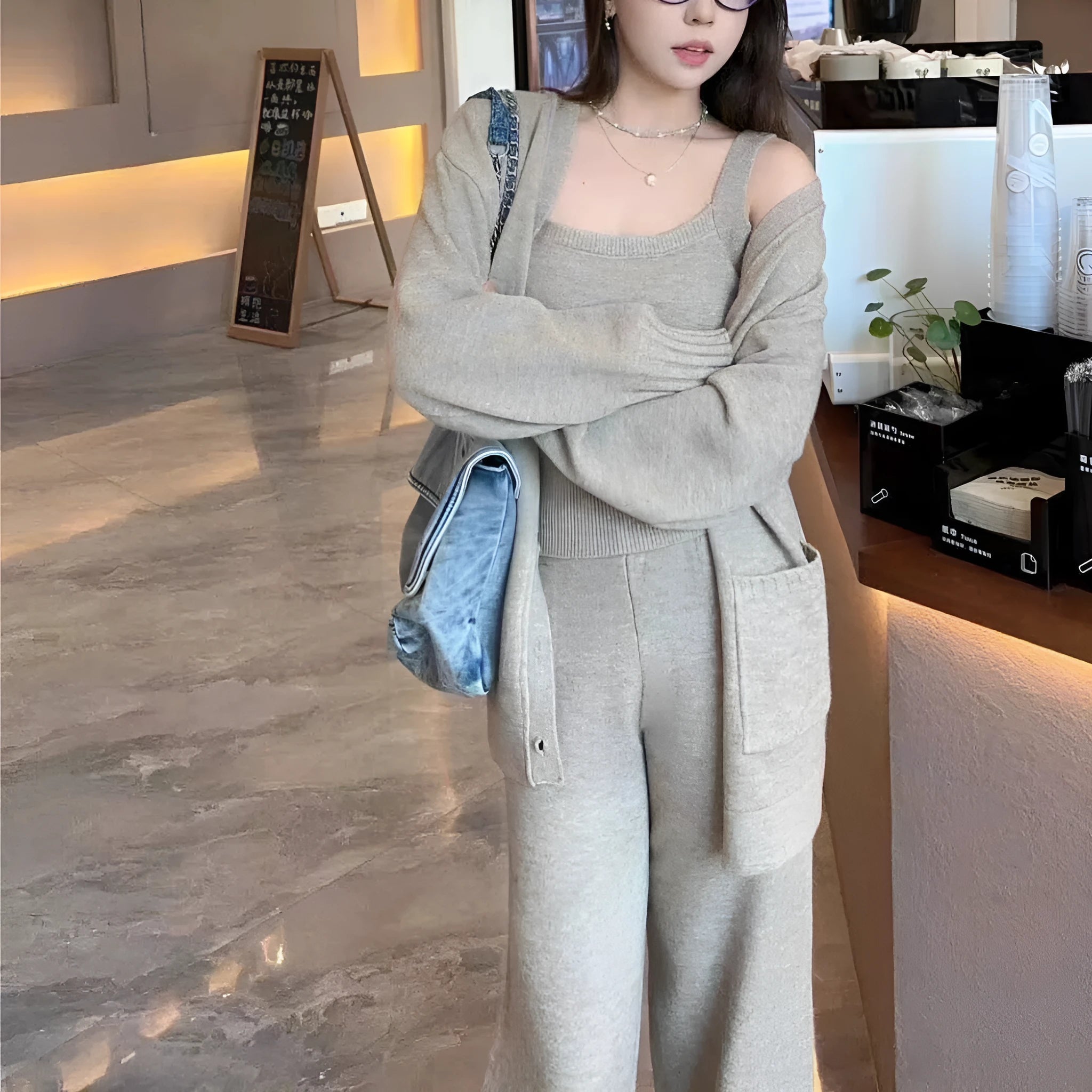 Women's loose-fit wool-blend cardigan three-piece set with vest and suspender trousers in beige.