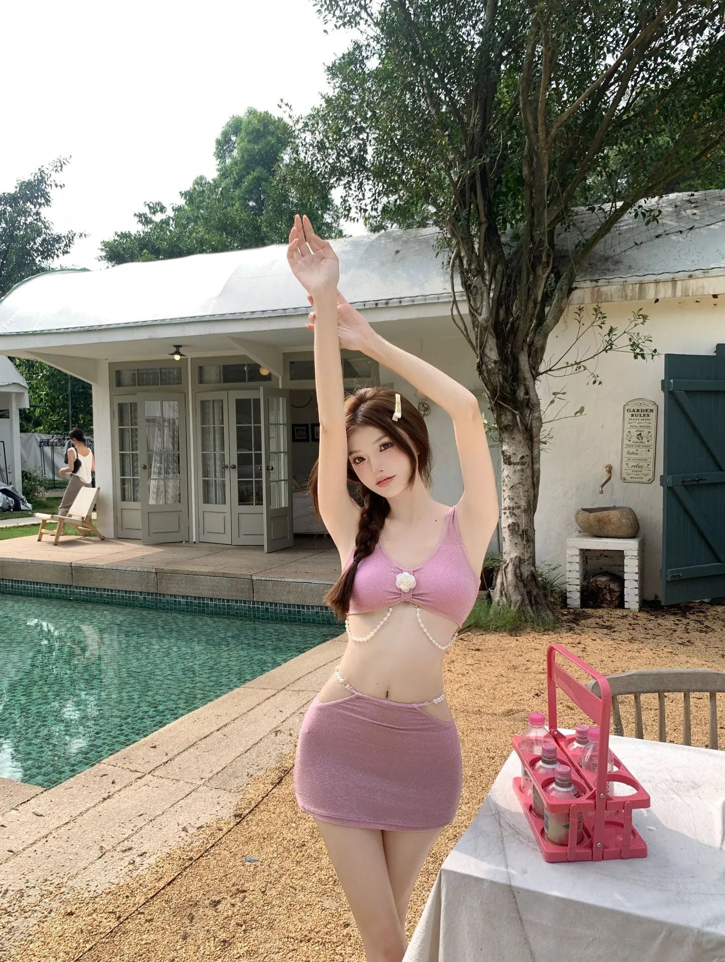 Women's pink and black three-piece polyester bikini set with briefs style and backless design