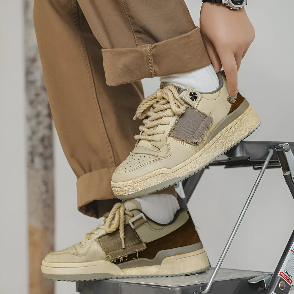Beige low-top skateboard shoes with microfiber upper and rubber sole on white background