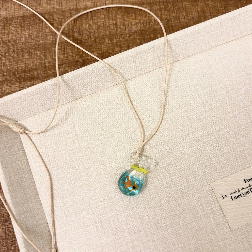 Women's pendant necklace with coloured glaze skirt joker character on a cotton linen clavicle chain.