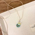 Women's pendant necklace with coloured glaze skirt joker character on a cotton linen clavicle chain.