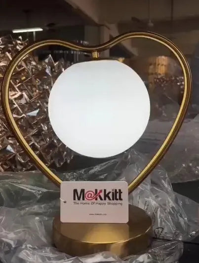 Heart shaped decorative LED lamp with warm white light on a table
