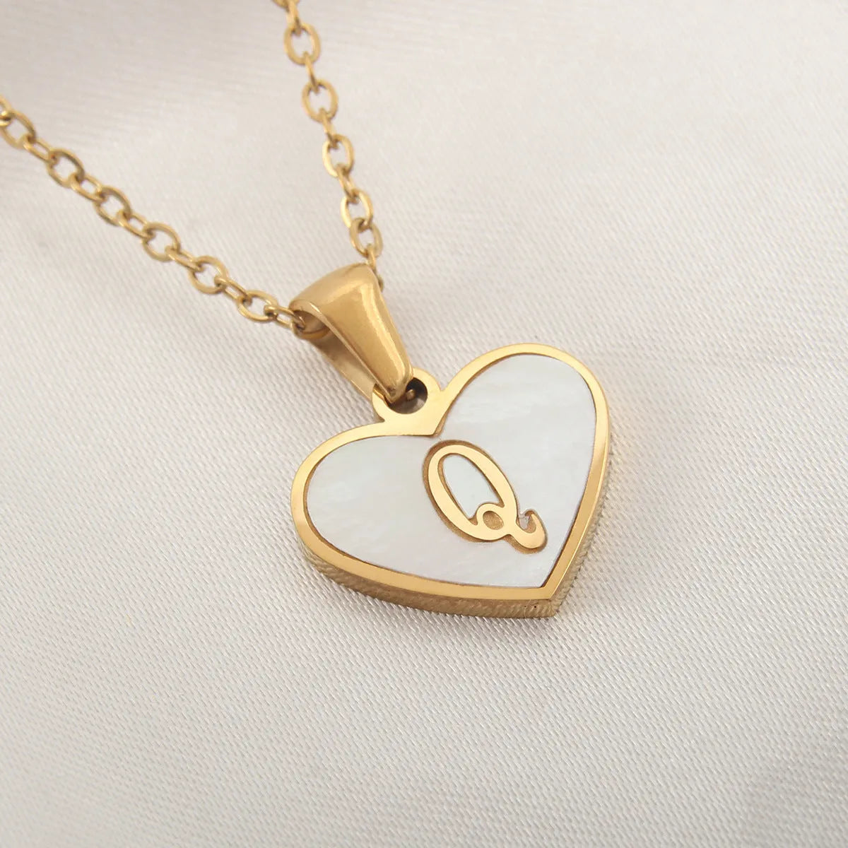Gold plated heart necklace with white shell detail on an adjustable chain