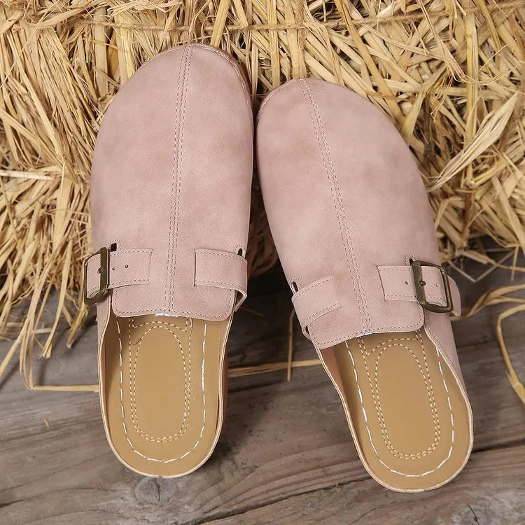 Women's casual wedge slippers in black with closed toe and rubber sole, shown from the side.