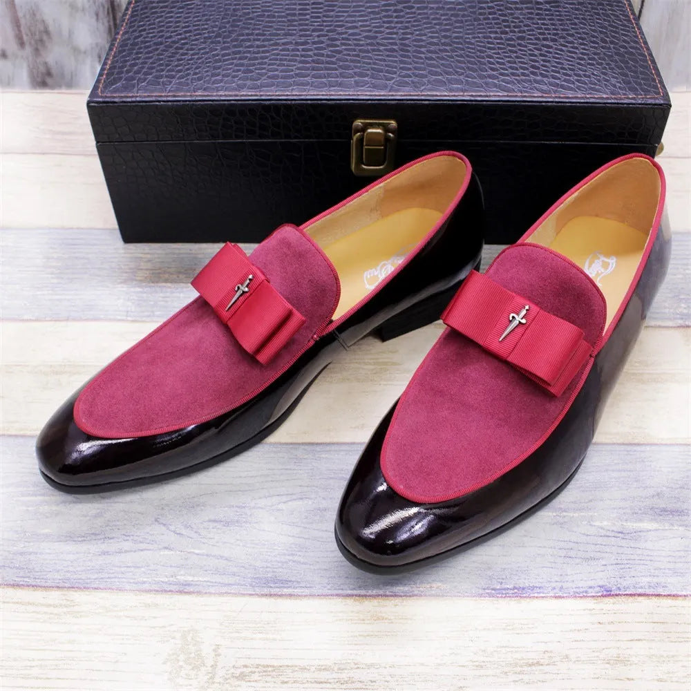 Men's black patent leather low-top shoes with a gold tassel detail on a white background.