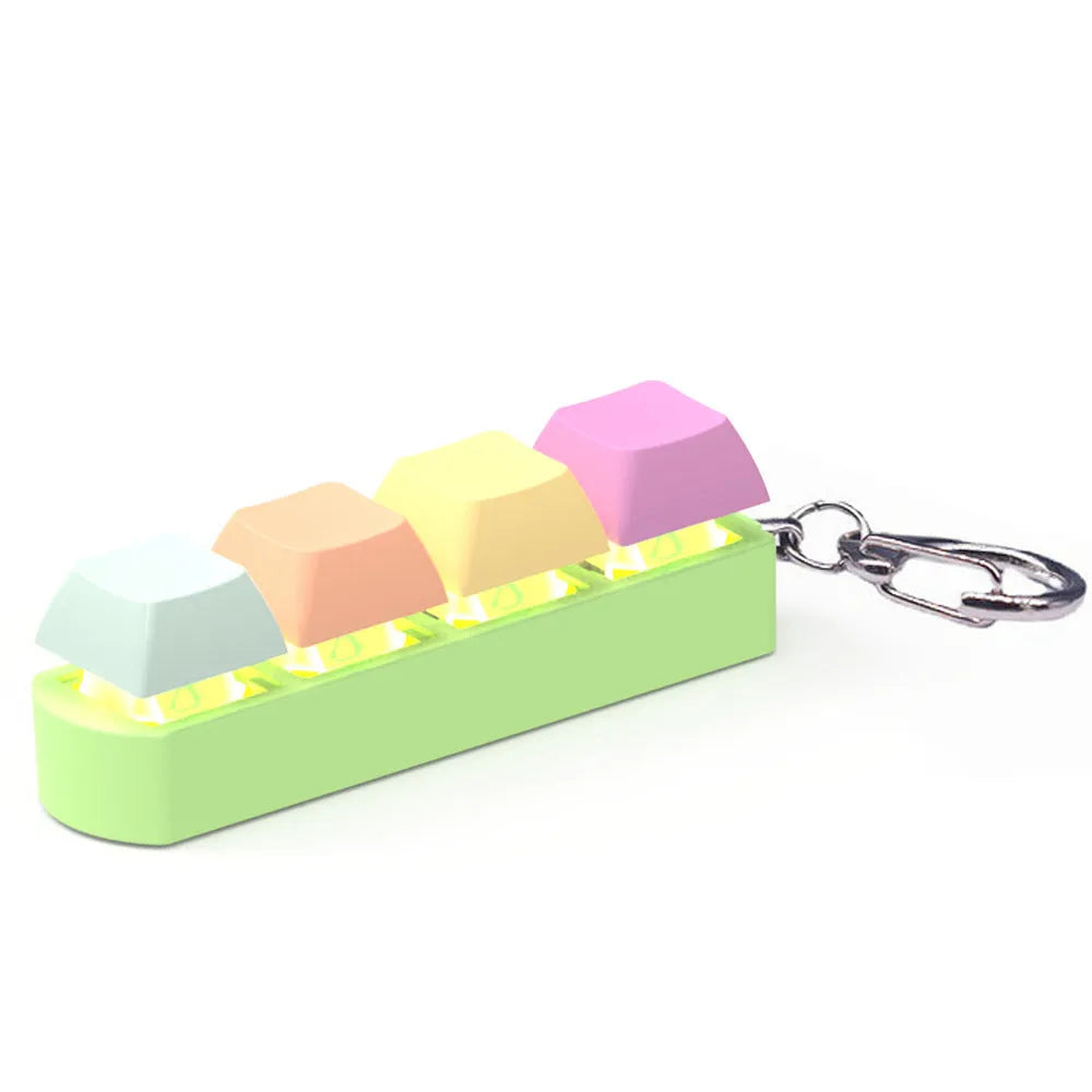 Compact 4-key mechanical keyboard switch tester on a desk, showing coloured ABS plastic construction.