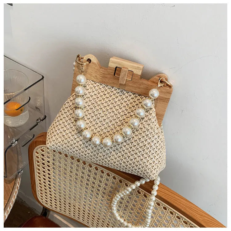 Women's straw woven shoulder bag with pearl chain strap in horizontal square shape