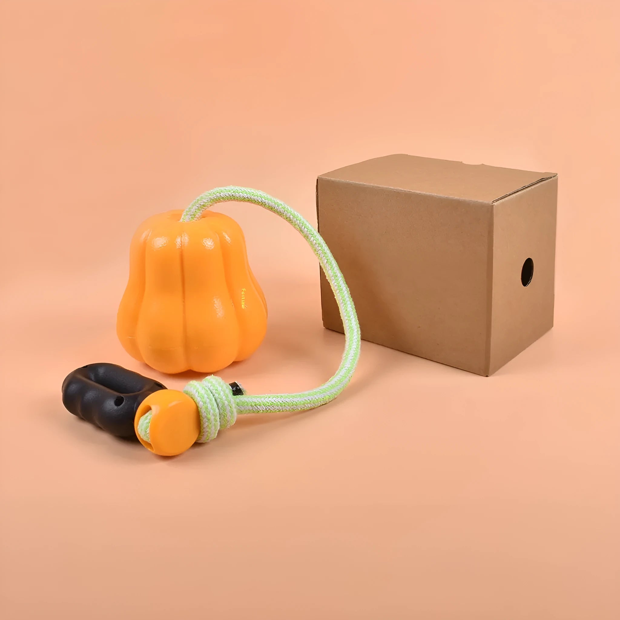Orange plastic dog chew toy with a blue rope attached, shown on a neutral background.
