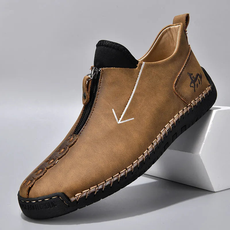 Men's black leather boots with front zipper and hand-stitched detailing, mid-calf height with low rubber sole