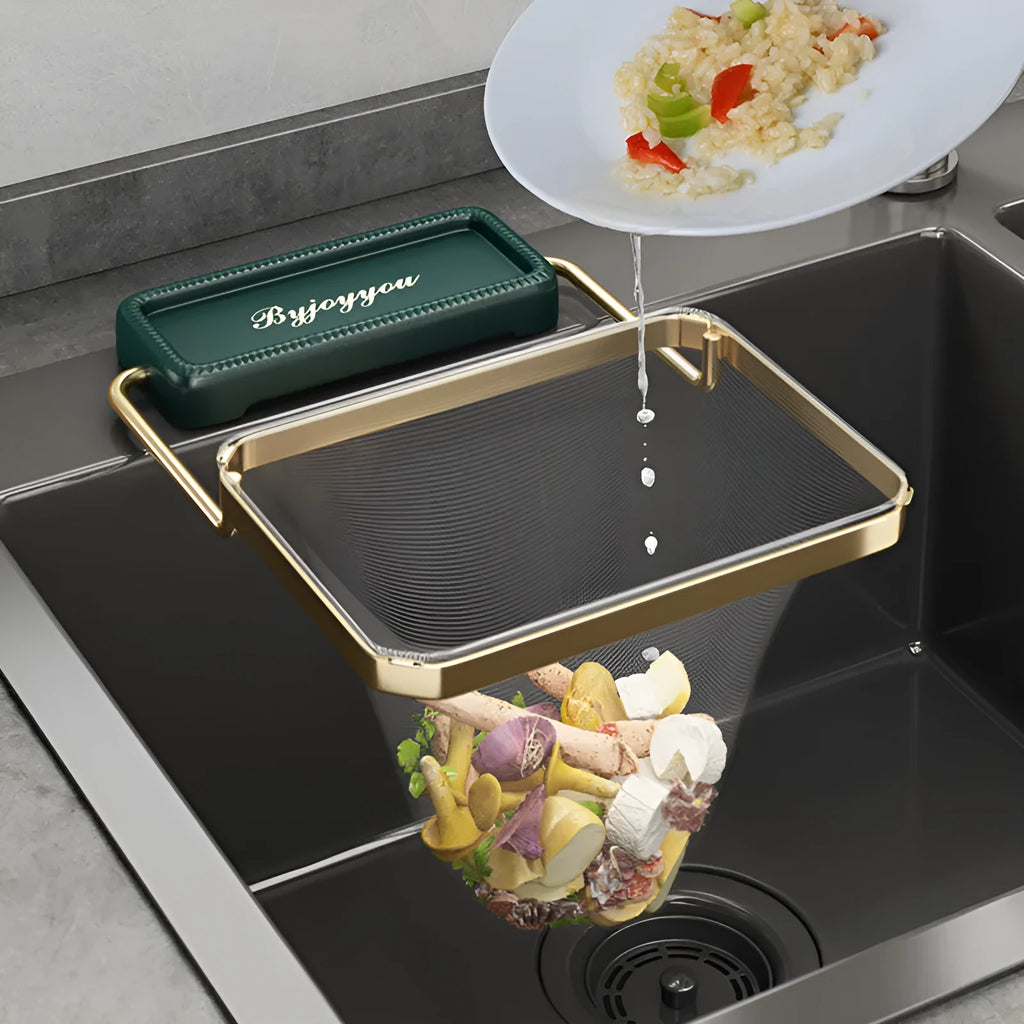 Foldable sink filter rack in dark green gold with disposable mesh bag on a stainless steel sink