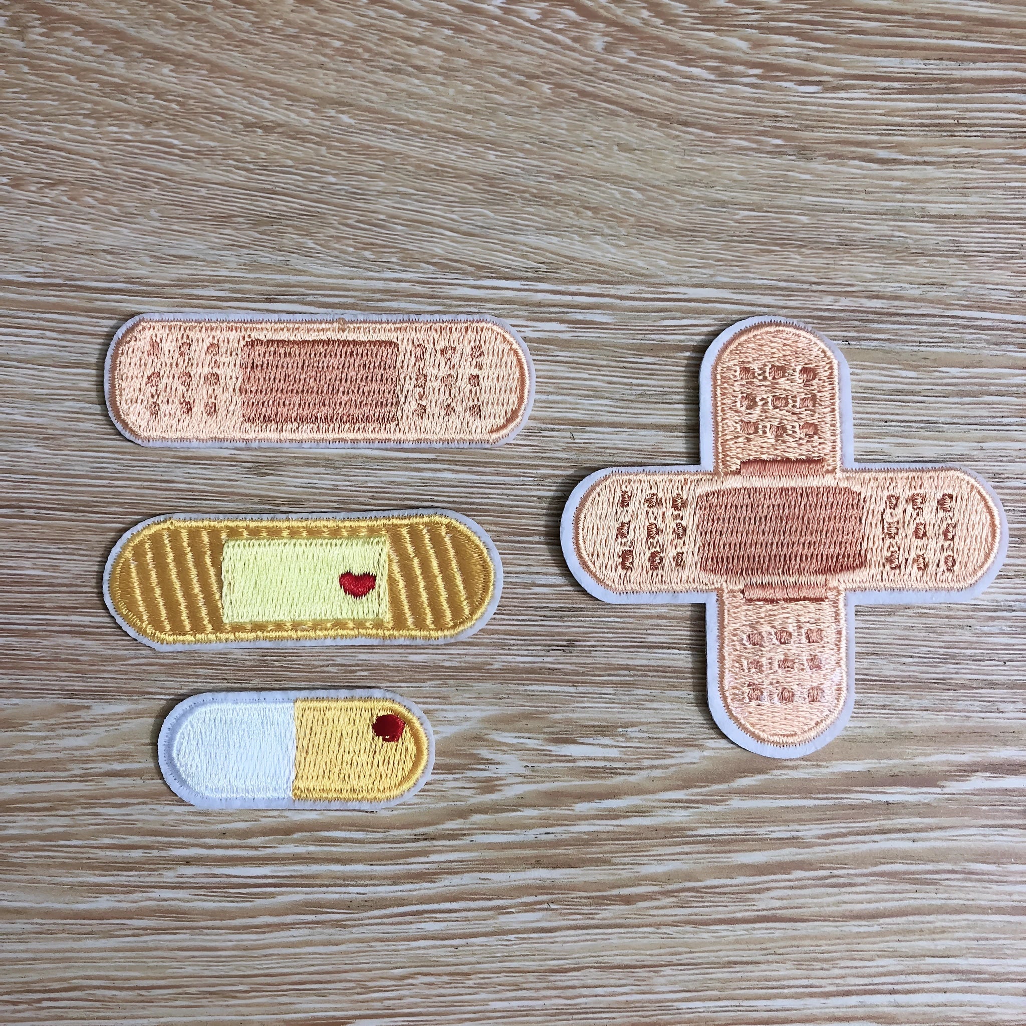 Set of ten embroidered fabric patch badges with lace designs for clothing customisation.