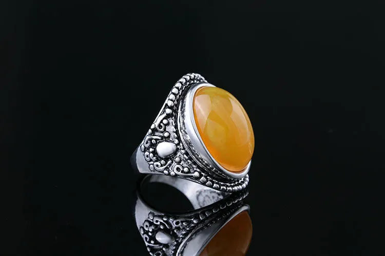 Retro geometric alloy ring in antique silver amber colour on a grey background.