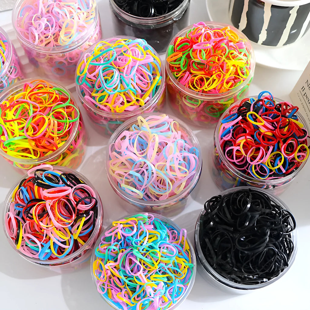 Pack of multicolour TPU baby hair ties for toddlers in a clear reusable container.