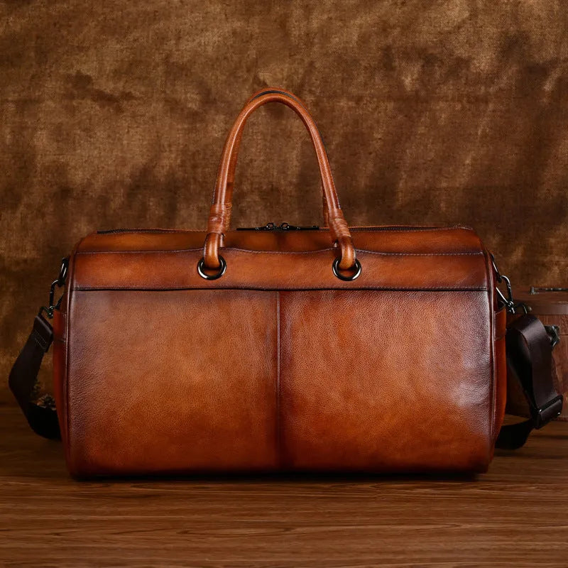 Genuine leather handmade retro travel bag in vintage brown with large capacity.