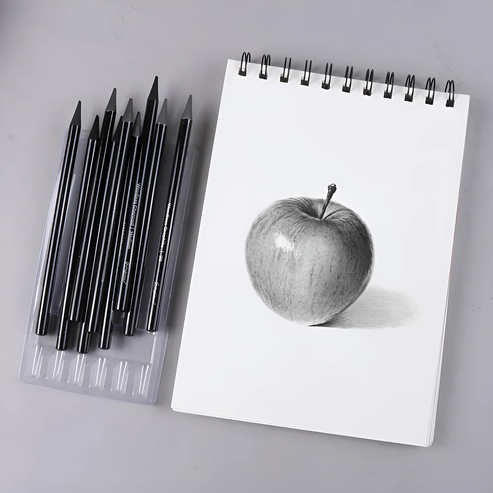 Carbonized Pencil Suit showing six graphite pencils and three carbonized pencils on wooden casing with suction card packaging
