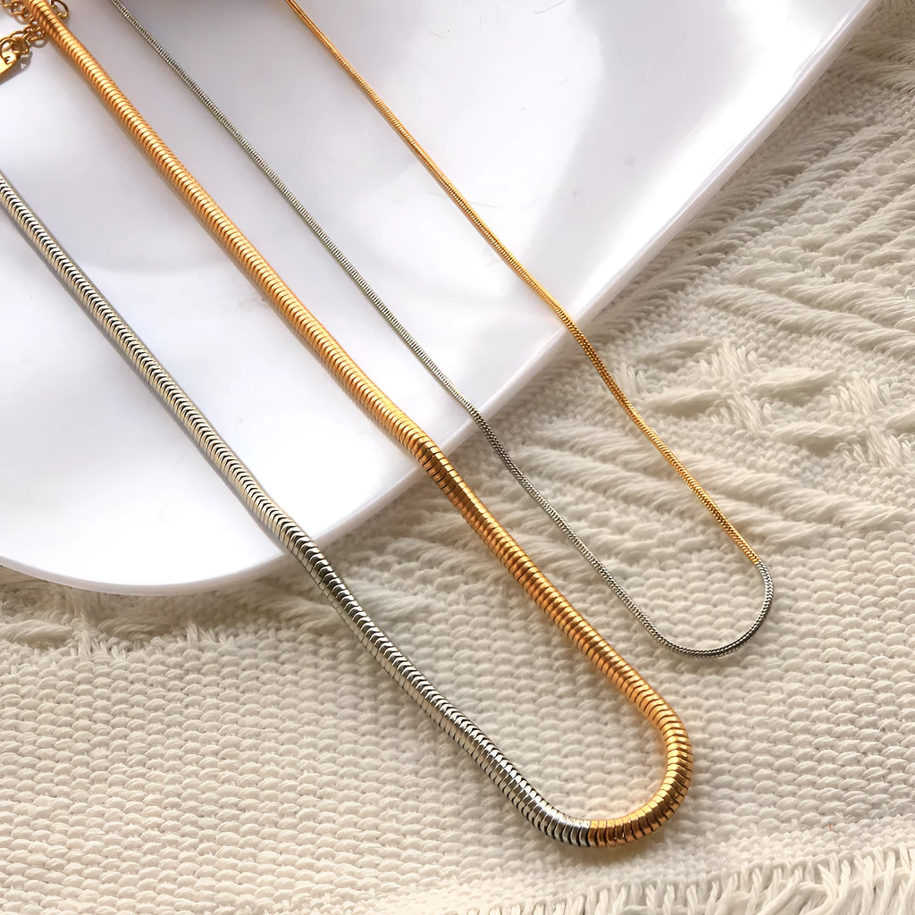 Gold-tone snake bone chain necklace with geometric lines and 3mm thick links