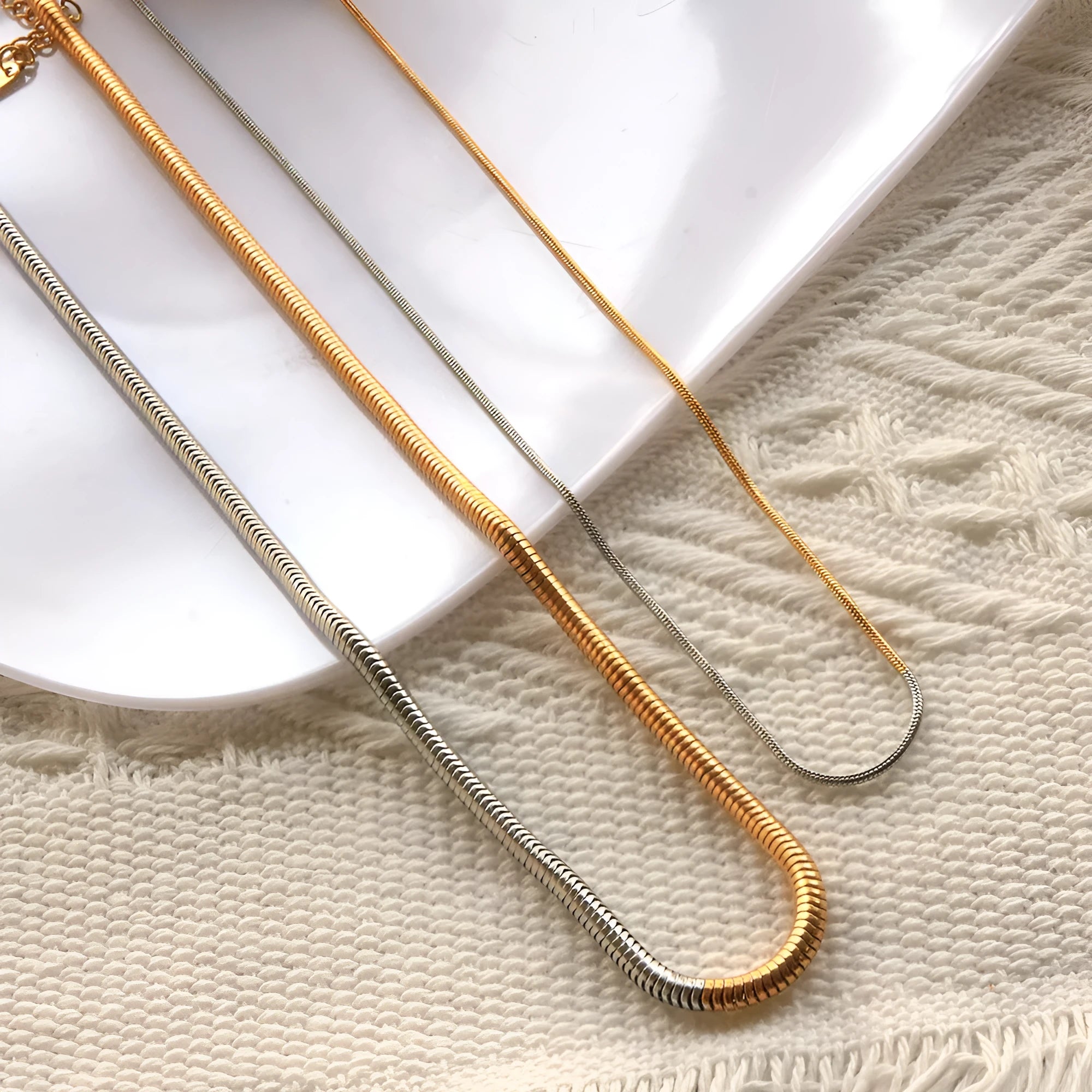 Gold-tone snake bone chain necklace with geometric lines and 3mm thick links