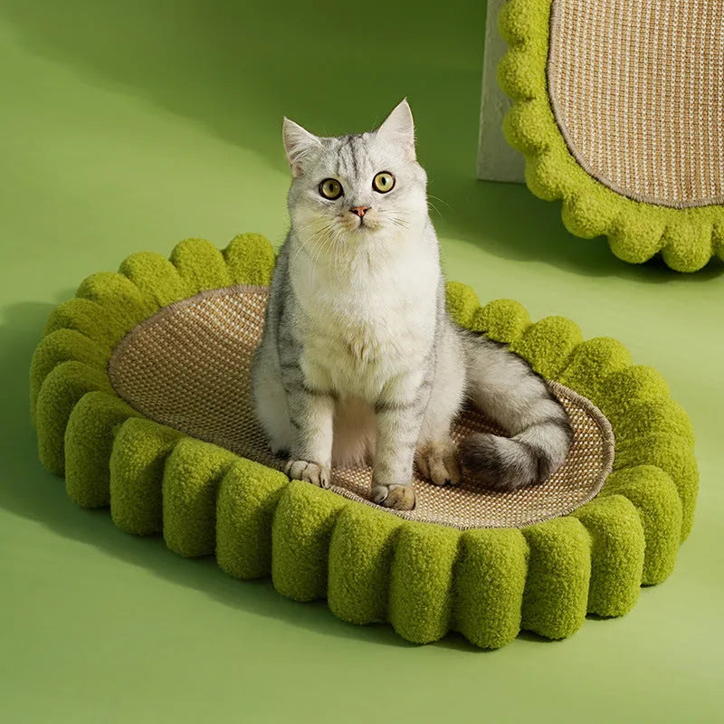 Green oval-shaped cat scratching pad with sisal fabric, serving as a lounge bed for cats.