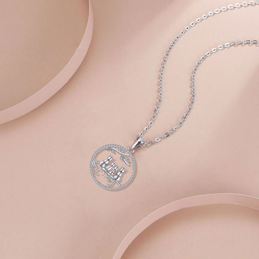 Copper necklace with a cat pendant on a cross chain, electroplated finish.