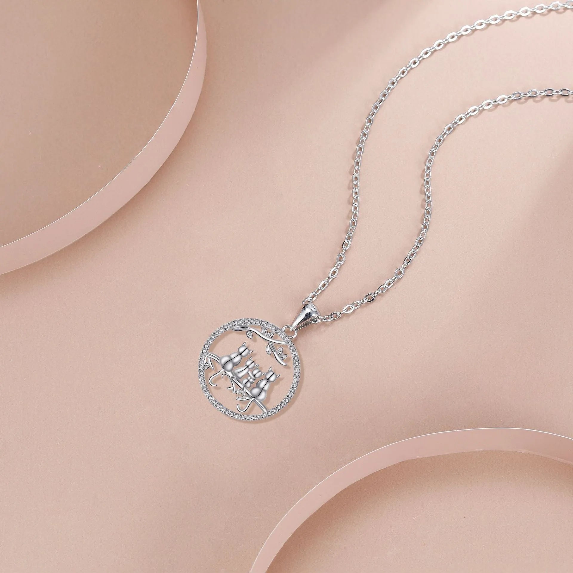 Copper necklace with a cat pendant on a cross chain, electroplated finish.