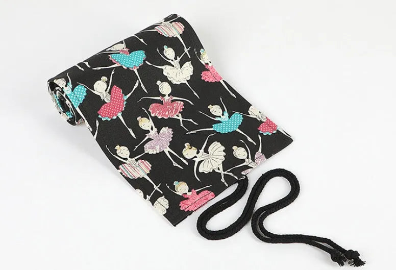 Square canvas rolling pencil case with ballet girl print, unrolled to show multiple pencil holes.