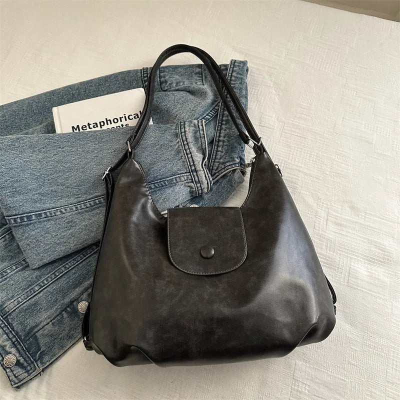 Leather women's shoulder bag in brown colour with single strap and structured horizontal design