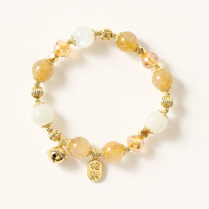 Gold rutilated quartz ringing bell bracelet with Korean style design and electroplated crystal construction