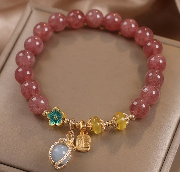 Red strawberry quartz bead bracelet with alloy chain and sparkling rhinestone details.