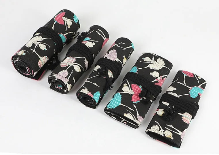 Square canvas rolling pencil case with ballet girl print, unrolled to show multiple pencil holes.