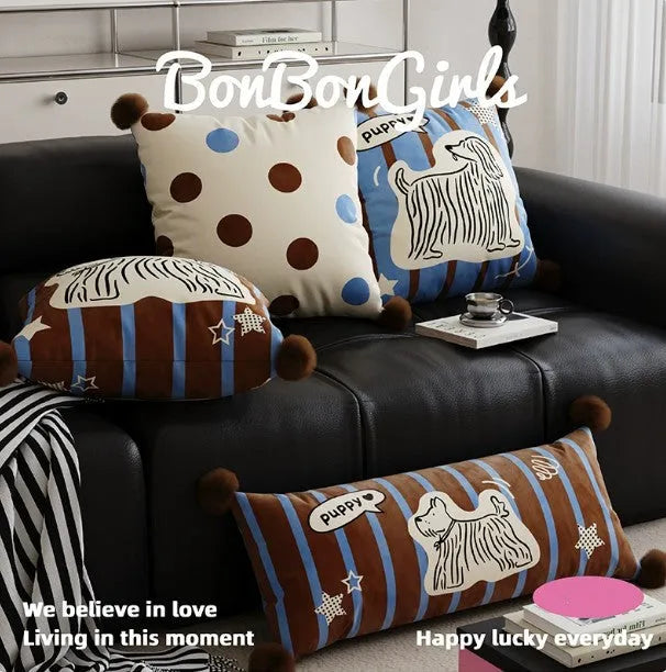 Blue cartoon animal print sofa cushion pillow on a sofa next to a brown one.