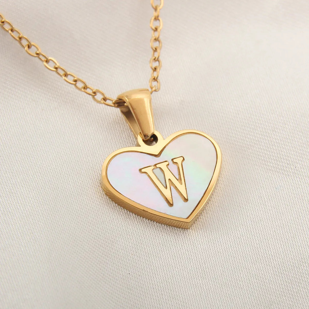 Gold plated heart necklace with white shell detail on an adjustable chain
