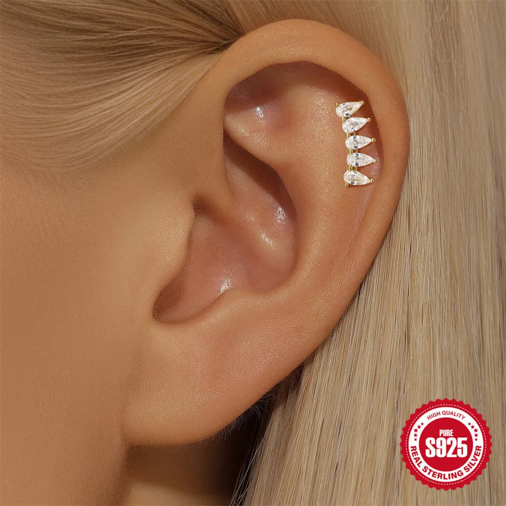 S925 sterling silver geometric earring with embedded moon, star, and diamond design on a gold-coloured background.