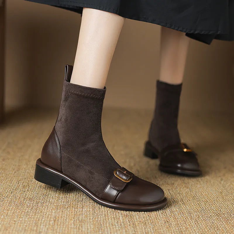 Women's black low heel Martin boots with lace-up front and belt buckle stitching detail on a round toe.