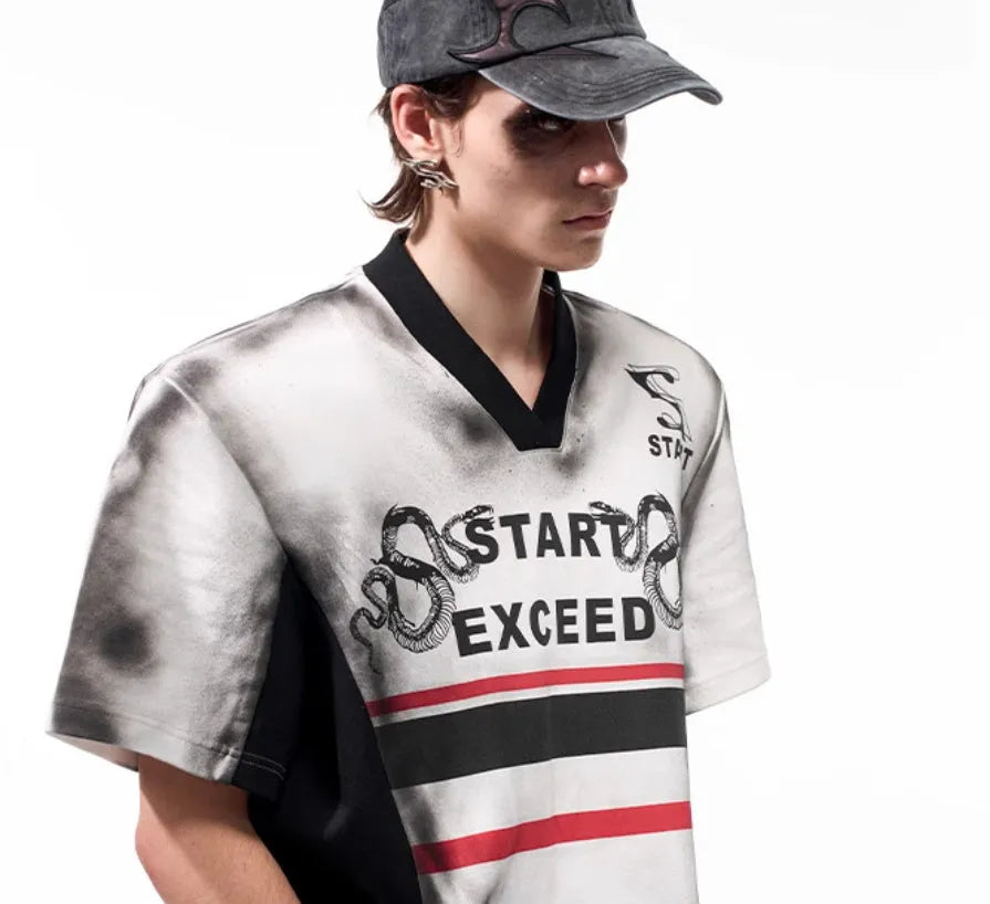 Women's V-neck short-sleeved top with a grey letter snake pattern print and padded shoulders.
